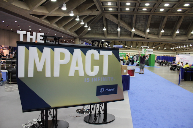 Large sign that says impact in the Phase2 booth
